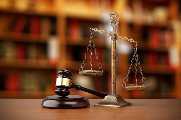 Services gavel and scales of justice on desk in law office
